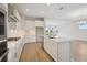 Bright kitchen features white cabinets, a center island with sink, and stainless steel appliances at 35617 Stableton Lane, Zephyrhills, FL 33541