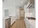 Modern kitchen featuring white cabinets, stainless steel appliances, subway tile backsplash, and center island at 35617 Stableton Lane, Zephyrhills, FL 33541