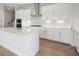 Modern kitchen featuring white cabinets, stainless steel appliances, subway tile backsplash, and center island at 35617 Stableton Lane, Zephyrhills, FL 33541