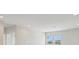 Bright living room with ample lighting, neutral walls, and large windows at 35617 Stableton Lane, Zephyrhills, FL 33541