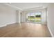 Bright living room with hardwood floors and large glass sliding doors with lake views at 35617 Stableton Lane, Zephyrhills, FL 33541