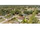 Aerial neighborhood view highlighting homes with mature landscaping and surrounding woods at 3610 Woodbridge Ave, North Port, FL 34287