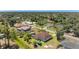 Aerial view of a neighborhood showcasing the layout of properties and surrounding trees at 3610 Woodbridge Ave, North Port, FL 34287