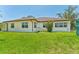 Exterior shot of a home showcasing a well-maintained lawn and tidy landscaping at 3610 Woodbridge Ave, North Port, FL 34287