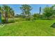 Expansive backyard with lush greenery and mature trees offering shade at 3610 Woodbridge Ave, North Port, FL 34287