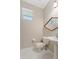 Bathroom features a pedestal sink, tile floors, and a decorative, hexagonal mirror above the sink at 3610 Woodbridge Ave, North Port, FL 34287