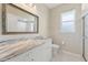 Well-lit bathroom featuring granite countertops and a walk-in shower at 3610 Woodbridge Ave, North Port, FL 34287