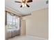 Neutral bedroom featuring tile flooring and a decorative ceiling fan at 3610 Woodbridge Ave, North Port, FL 34287