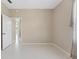 Neutral bedroom with tiled floor, and doorway showing a view to the exterior at 3610 Woodbridge Ave, North Port, FL 34287