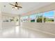 Bright and sunny bonus room with tile floors, large windows, and ceiling fan at 3610 Woodbridge Ave, North Port, FL 34287