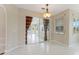 Bright dining room with sliding glass doors, decorative lighting and tile floors at 3610 Woodbridge Ave, North Port, FL 34287