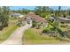 Well-manicured lawn and landscaping accent this charming single Gathering home with a curved driveway at 3610 Woodbridge Ave, North Port, FL 34287