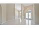 Bright foyer featuring tile flooring, soaring ceilings, arched windows, and elegant chandeliers at 3610 Woodbridge Ave, North Port, FL 34287