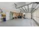 Spacious garage with high ceilings, ample storage shelving, and lots of room for parking at 3610 Woodbridge Ave, North Port, FL 34287