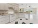 Well-equipped kitchen with granite countertops, white cabinets, and tile flooring at 3610 Woodbridge Ave, North Port, FL 34287