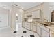 Kitchen boasts white cabinetry, granite countertops, white appliances, and tiled backsplash at 3610 Woodbridge Ave, North Port, FL 34287
