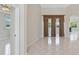 Spacious living area with large tile flooring, an archway, and sliding glass doors at 3610 Woodbridge Ave, North Port, FL 34287