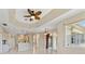 Open concept living room featuring tile flooring, stylish ceiling fan and plenty of natural light at 3610 Woodbridge Ave, North Port, FL 34287