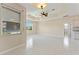 Spacious main bedroom with tile floors, fan and view to ensuite bath at 3610 Woodbridge Ave, North Port, FL 34287