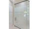 Spacious shower with white tiling, glass door, shower bench, and safety bar at 3610 Woodbridge Ave, North Port, FL 34287