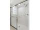 Shower featuring white tile, safety bar and dual shower heads at 3610 Woodbridge Ave, North Port, FL 34287