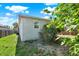 View of the back of the home and yard showing lush foliage at 3708 N 56Th St, Tampa, FL 33619