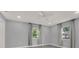 Bright bedroom with two windows and neutral walls and floors at 3708 N 56Th St, Tampa, FL 33619