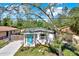 Charming home featuring a bright blue front door and well-maintained landscaping at 3708 N 56Th St, Tampa, FL 33619