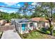Charming home featuring a bright blue front door and well-maintained landscaping at 3708 N 56Th St, Tampa, FL 33619