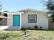 Attractive one-story home features a bold turquoise front door and well-maintained lawn at 3708 N 56Th St, Tampa, FL 33619