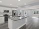 Well-lit kitchen featuring white cabinets, gray countertops, and stainless steel appliances at 3708 N 56Th St, Tampa, FL 33619