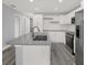 Modern kitchen with stainless steel appliances, stylish tile backsplash, and a functional island at 3708 N 56Th St, Tampa, FL 33619