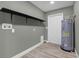 Functional laundry room with open shelving and modern water heater at 3708 N 56Th St, Tampa, FL 33619