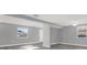 Spacious living room featuring gray walls, white trim, and modern gray-toned flooring at 3708 N 56Th St, Tampa, FL 33619