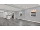 Open living space with kitchen island and gray walls and floors at 3708 N 56Th St, Tampa, FL 33619