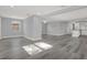 Bright and open living room area featuring gray walls and modern vinyl floors at 3708 N 56Th St, Tampa, FL 33619
