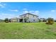 Expansive backyard features lush green lawn, a covered patio, and well-kept landscaping at 3952 Almond Brook Blvd, Land O Lakes, FL 34638