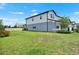 Spacious backyard featuring lush green grass and a well-maintained two-story house at 3952 Almond Brook Blvd, Land O Lakes, FL 34638