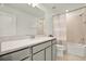 Clean bathroom with a large vanity, shower-tub combination, and tile surround at 3952 Almond Brook Blvd, Land O Lakes, FL 34638