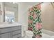 Modern bathroom featuring neutral tones, a quartz countertop, and a floral shower curtain at 3952 Almond Brook Blvd, Land O Lakes, FL 34638