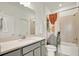 Bright bathroom featuring a shower with colorful curtain and an elegant quartz vanity at 3952 Almond Brook Blvd, Land O Lakes, FL 34638