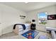 Bright bedroom features a space-themed rug, a storage bed, and a large window at 3952 Almond Brook Blvd, Land O Lakes, FL 34638