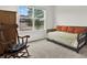 Bedroom with a daybed, rocking chair, and a large window offering natural light at 3952 Almond Brook Blvd, Land O Lakes, FL 34638
