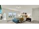 Bedroom with a blue bench at the foot of the bed and natural light from the windows at 3952 Almond Brook Blvd, Land O Lakes, FL 34638