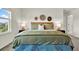 Comfortable bedroom with a plush bed, stylish lamps, and decorative wall art for a cozy ambiance at 3952 Almond Brook Blvd, Land O Lakes, FL 34638