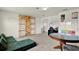 Versatile bonus room with study area, wall climbing gym, and modular couch for a flexible living space at 3952 Almond Brook Blvd, Land O Lakes, FL 34638