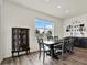 Bright dining room with modern furnishings next to living room and kitchen at 3952 Almond Brook Blvd, Land O Lakes, FL 34638