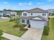 Two-story house with neutral colored exterior, a two-car garage, and landscaped yard at 3952 Almond Brook Blvd, Land O Lakes, FL 34638