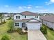 Aerial view of the two-story home features lush landscaping and a two-car garage at 3952 Almond Brook Blvd, Land O Lakes, FL 34638