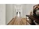 Inviting hallway featuring wood flooring and neutral wall color at 3952 Almond Brook Blvd, Land O Lakes, FL 34638